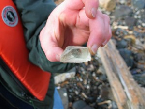 When walking over the cobble areas on the south side beaches at Race Rocks, we often turn up pieces of very thick glass. This one was found in April, 2006.This glass came from the Fresnel lens on the original light installed in 1860, seen here on the right in an artists drawing.