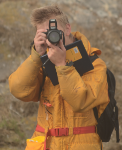 Journal and camera at the ready for marine science observations.