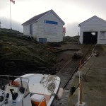 A large male elephant seal lay on the winch cable for a few minutes, pausing  the boat being lowered into the water.